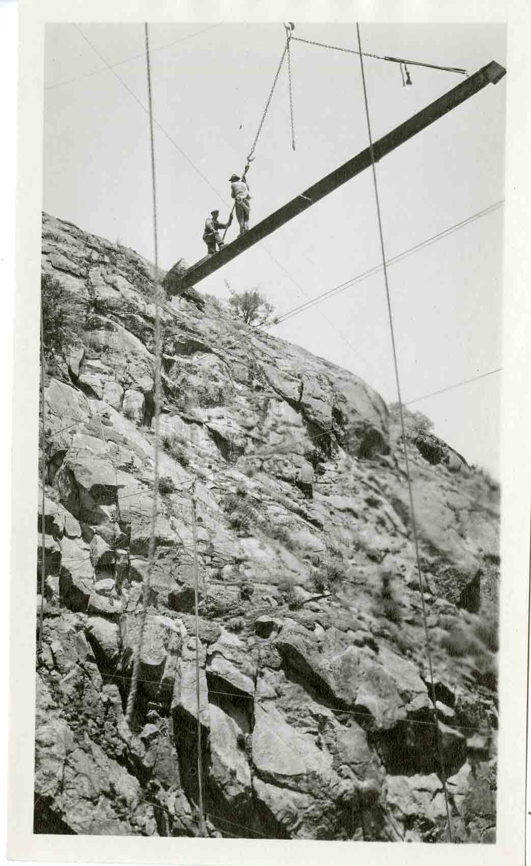 Image of men doing high wire work.